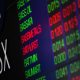 Aussie shares edge higher as iron ore tumbles