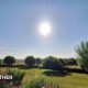 Sunny landscaped garden with flowers, lawn and countryside views in Bowden, The Scottish Borders