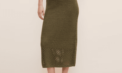 woman wears crocheted olive midi skirt where the bottom half of the skirt doesn't have a slip