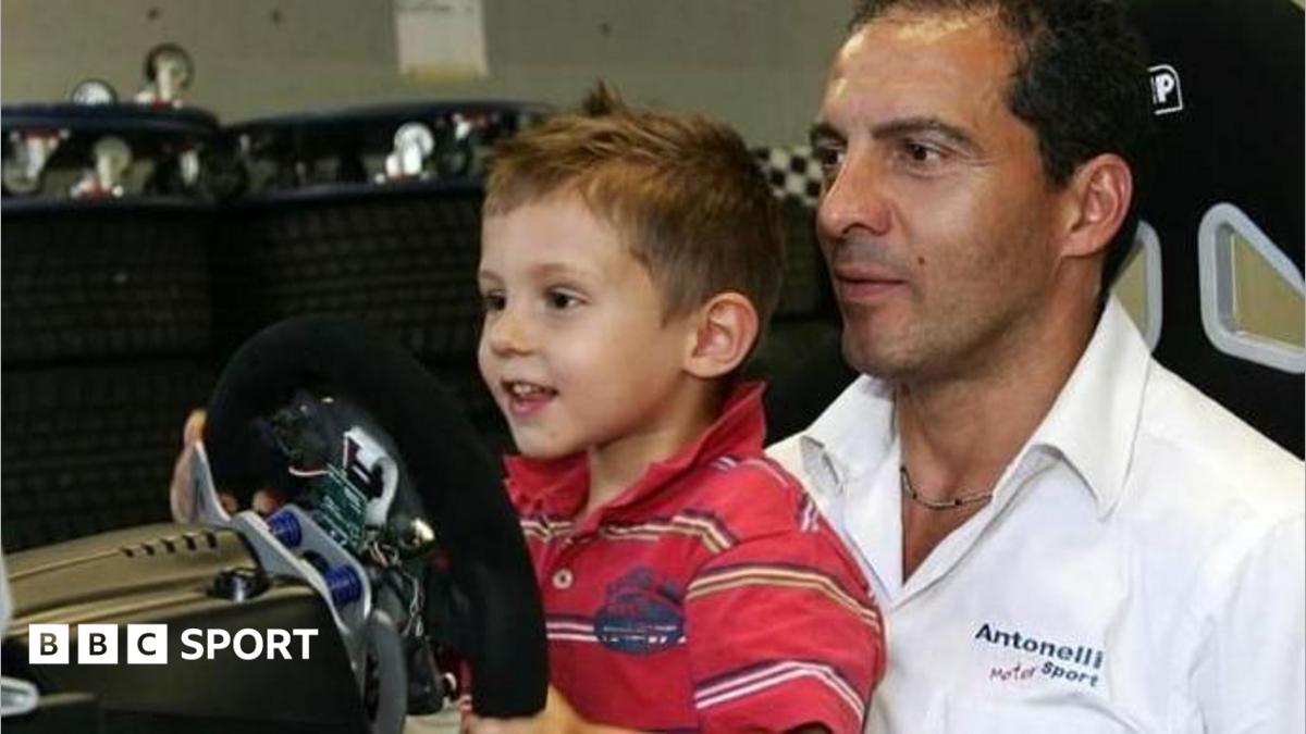A young Kimi Antonelli sitting in a go-kart while wearing racing overalls and a racing helmet