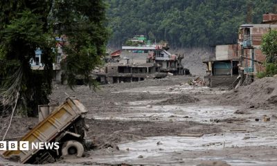 Mud covers houses and a road following a flash flood at Trishuli in Nuwakot district, Nepal, August 26, 2026.