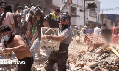 Residents dig through the debris of a collapsed building after an earthquake, in Cali, Colombia