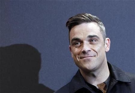British singer Robbie Williams arrives on the red carpet for the German premiere of ''Cars 2'' in Munich July 28, 2011.