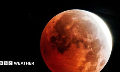 Full moon with a red tinge over the majority of the Moon