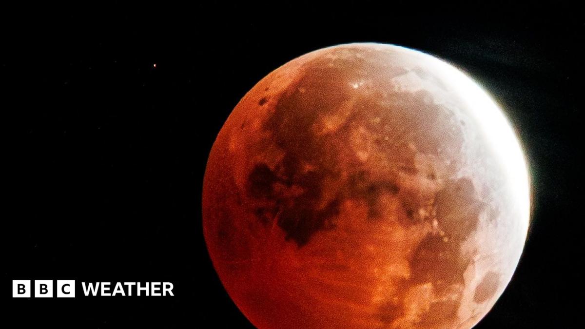 Full moon with a red tinge over the majority of the Moon