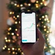 A person holding a smartphone displaying a stock market chart for AAPL on the NASDAQ exchange