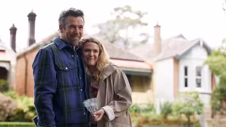 Patrick Brammall, and Harriet Dyer hug on the front lawn in 'Colin from Accounts'.