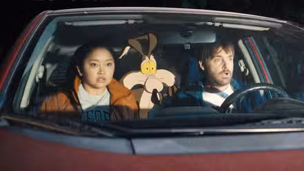 Will Forte drives a vehicle with Wile E. Coyote in the back in 'Coyote vs. Acme' image