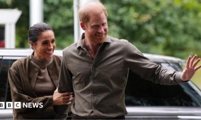 Prince Harry and Meghan waving as they arrive at the Australian National Veterans Arts Museum in Melbourne, Australia on 14 April 2026.
