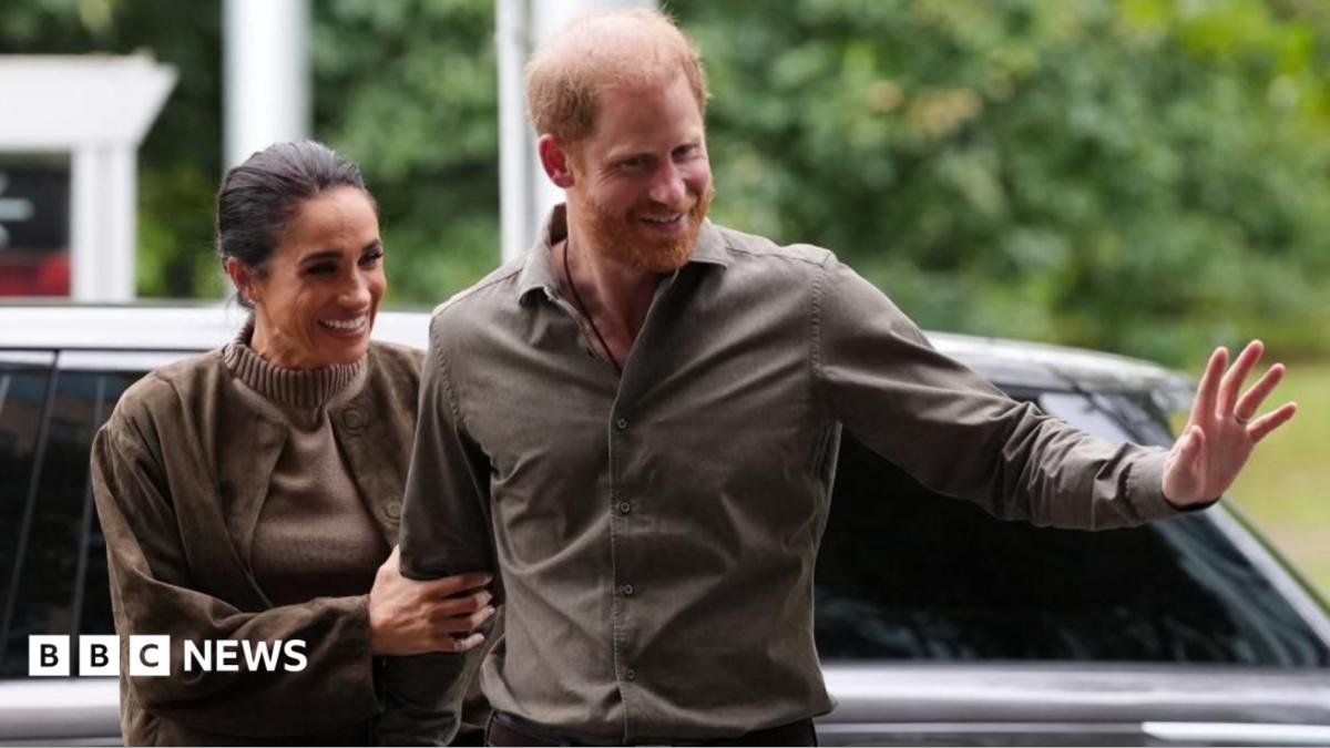 Prince Harry and Meghan waving as they arrive at the Australian National Veterans Arts Museum in Melbourne, Australia on 14 April 2026.