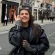 Ella Hewitt stands in a street