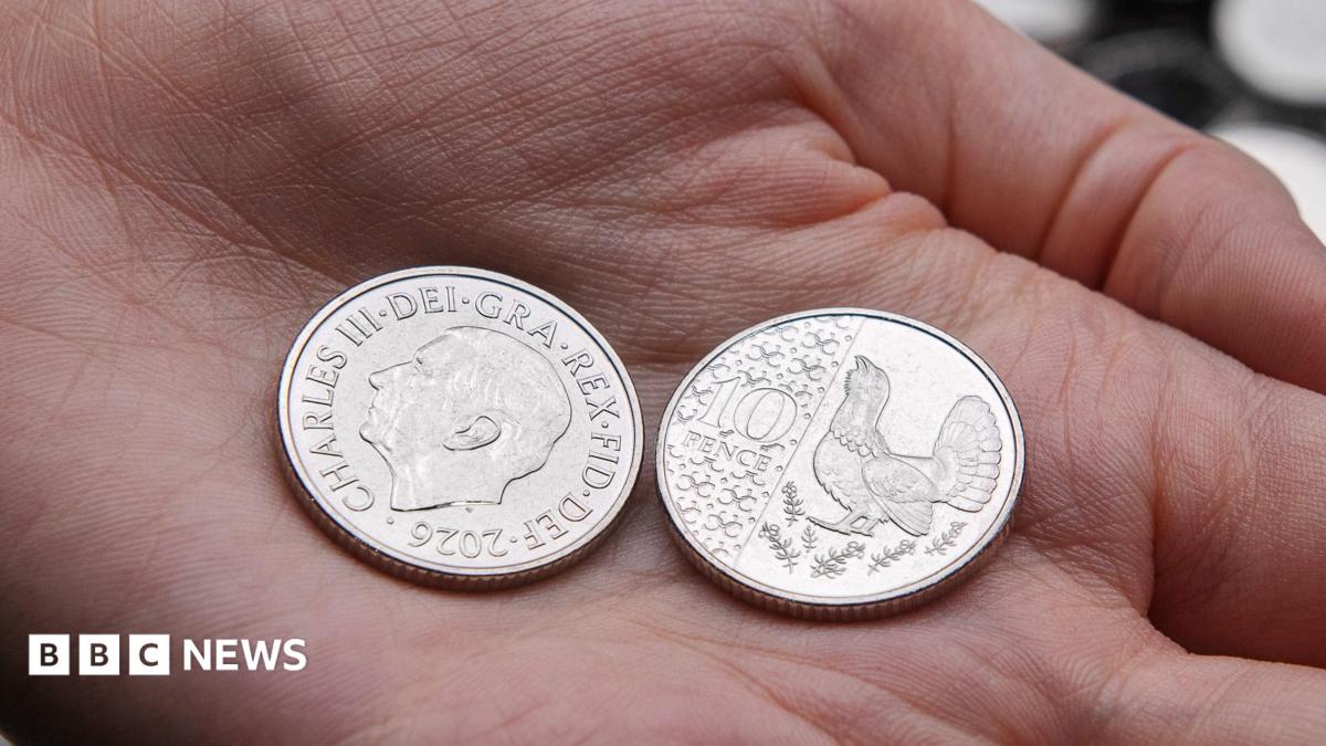 New 10p coin in the palm of someone's hand with one coin on the side showing an image of King Charles and dated 2026, with another coin on the reverse side showing a capercaillie.