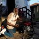 Anthony Lewis repairs a generator at his home while coping without electricity, as thousands of residents remain without power more than a week after severe storms struck Gary, Indiana.