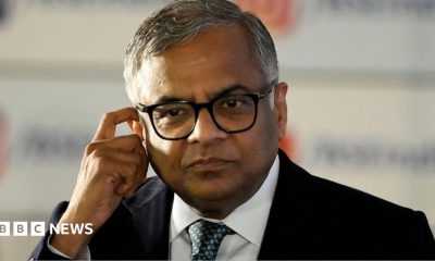 N Chandrasekaran, wearing a dark suit, white shirt and thick-rimmed glasses, touches his ear in this photo taken at the Bombay Stock Exchange in Mumbai, India, on November 12, 2025.