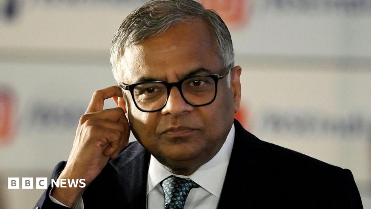 N Chandrasekaran, wearing a dark suit, white shirt and thick-rimmed glasses, touches his ear in this photo taken at the Bombay Stock Exchange in Mumbai, India, on November 12, 2025.