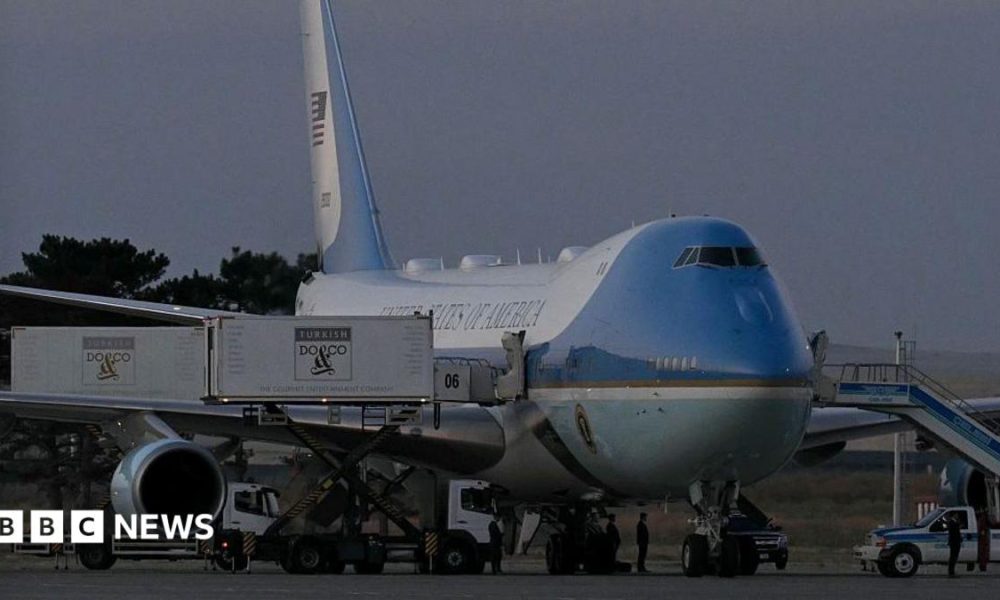 A catering truck parked alongside the old Air Force One jet prior to departure from Ankara