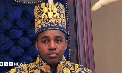 King Oyo pictured at 18 during his coronation wearing a gold embroidered jacket and hat.