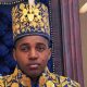 King Oyo pictured at 18 during his coronation wearing a gold embroidered jacket and hat.