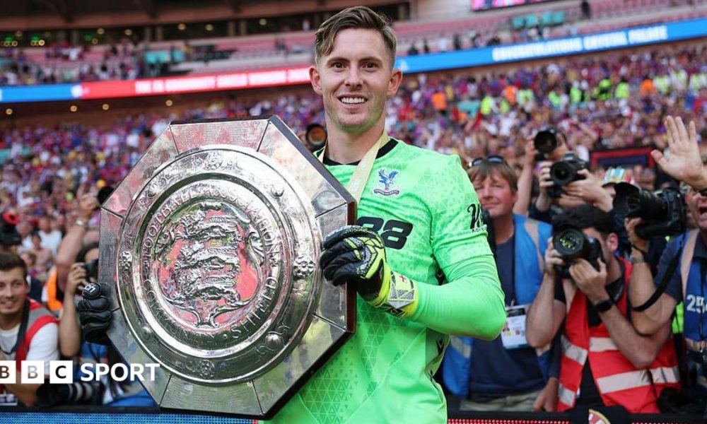 Crystal Palace keeper Dean Henderson holds up the Community Shield after his side's penalty shootout win over Liverpool