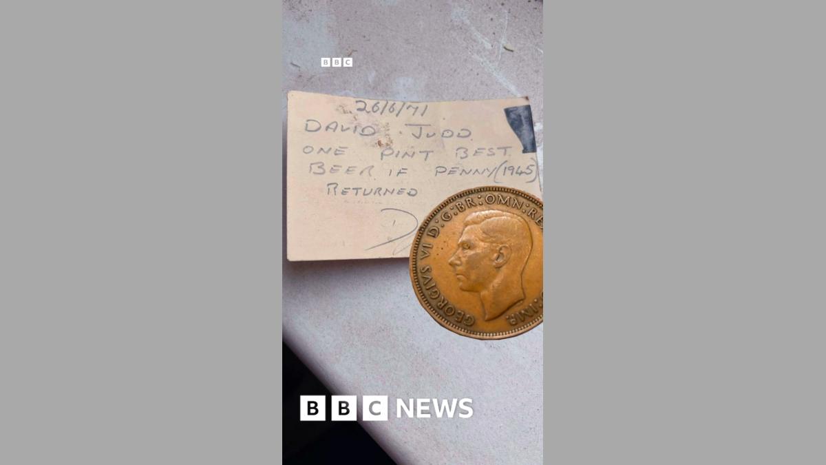 An old penny on top of a piece of card - on it is written: David Judd - one pint of best beer if penny returned