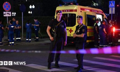Armed Moscow police stand guard in front of an ambulance near the scene of an explosion near the centre of the city.
