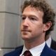 Mark Zuckerberg, CEO of Meta, wearing a dark blue suit with a dark red tie