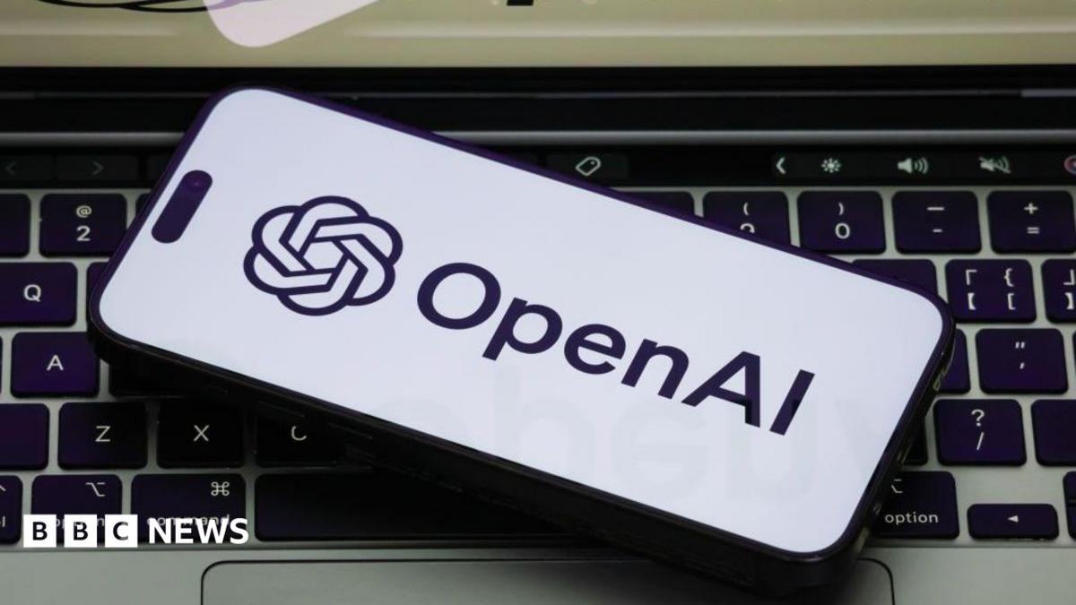 The OpenAI logo on a white phone backgorund, the phone is on a laptop keyboard