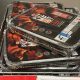 Disposable barbecues entitled "Put Me Out" piled up in a wire basket in a shop