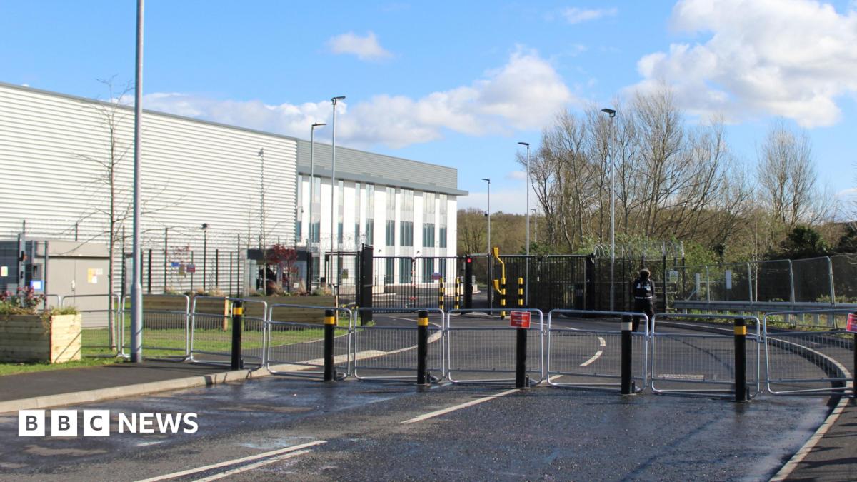 The Elbit Systems UK factory in Filton, near Bristol. There are metal gates blocking access to the building, which is white and grey.