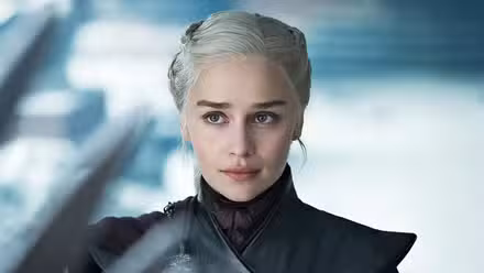Emilia Clarke as Daenerys Targaryen looking at the Iron Throne in Game of Thrones.