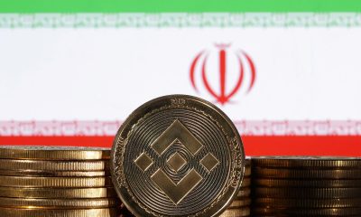 Illustration shows representations of cryptocurrency Binance and Iran flag