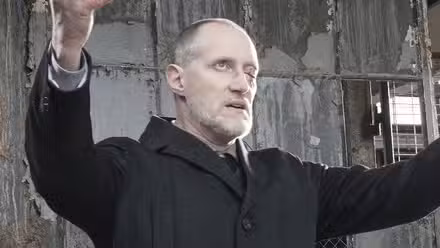 Christopher Heyerdahl as Grigori Efimovich Rasputin raises his arms dramatically in a scene from the film Midnight, Texas Unearthed.