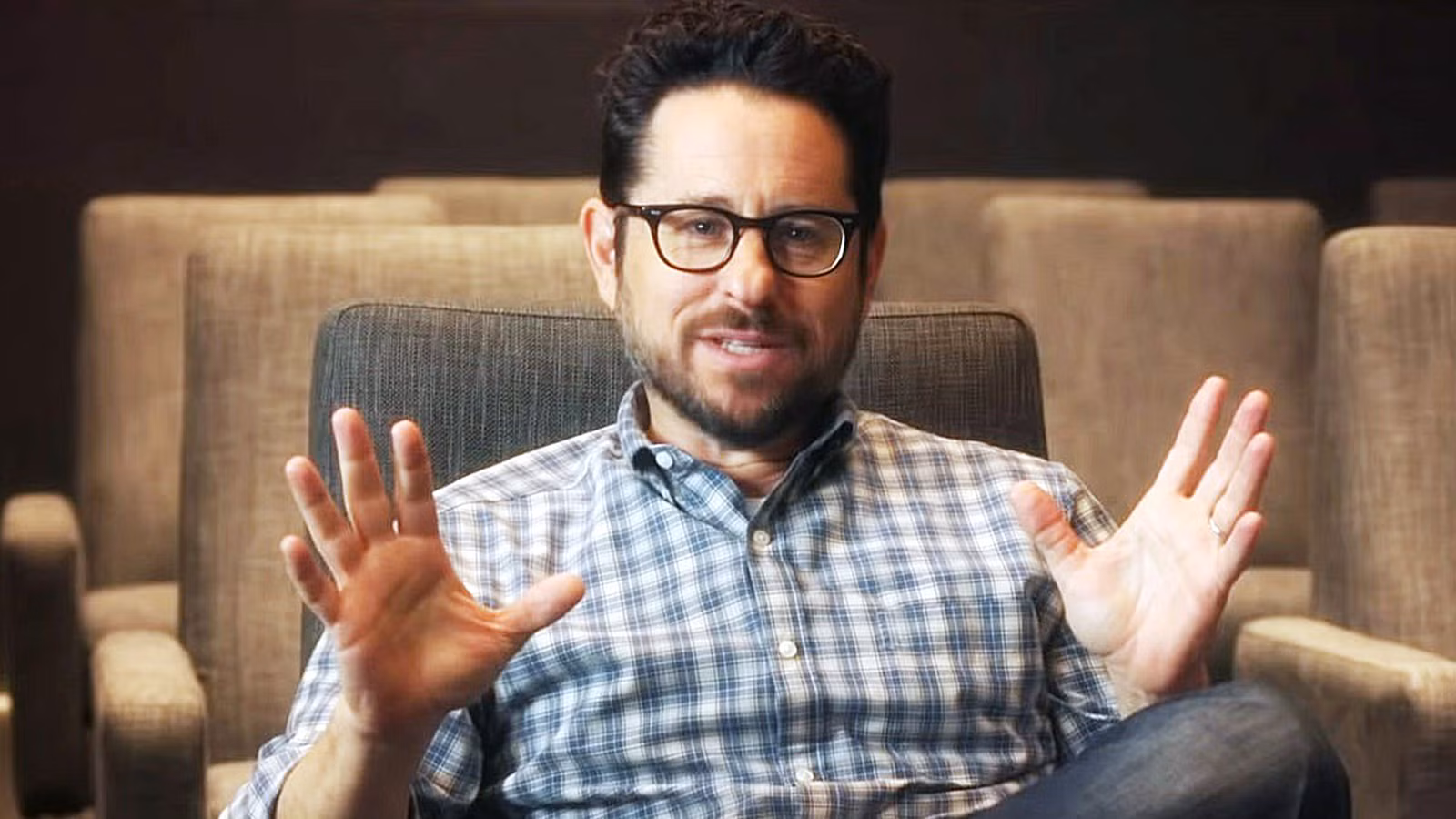 J.J. Abrams sitting and talking in a chair 