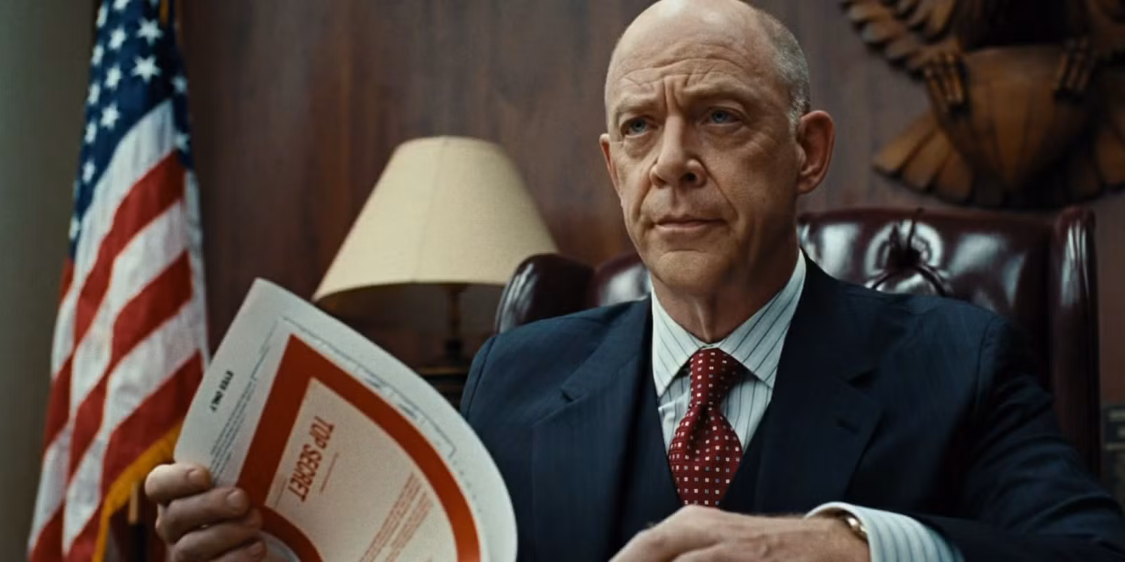 J.K. Simmons as a CIA Superior looking through a file in 'Burn After Reading'