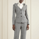 woman wears black and white checked suit