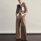 woman wears wide-leg pantsuit; her blouse is untucked and she's wearing a floppy bowtie (no comment on the bowtie)