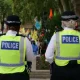 Two uniformed police officers walking with their back to the camera. Hackers have infilrated the national police system.