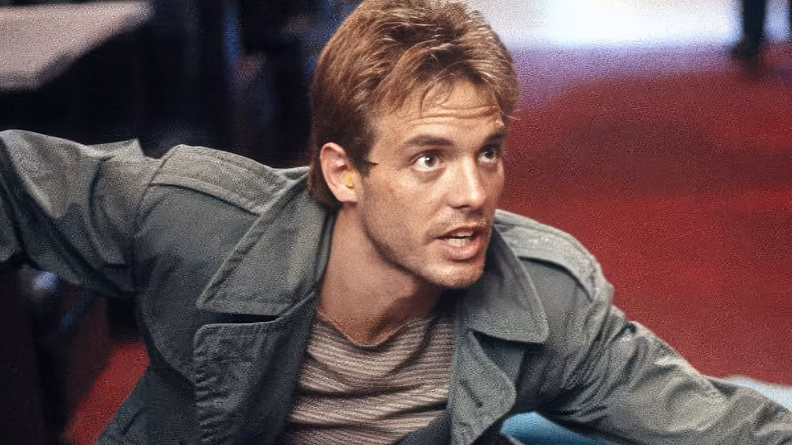 Michael Biehn crouched and protecting someone in 'The Terminator'