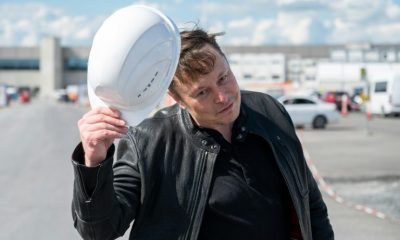 Tesla CEO Elon Musk tips his hard hat