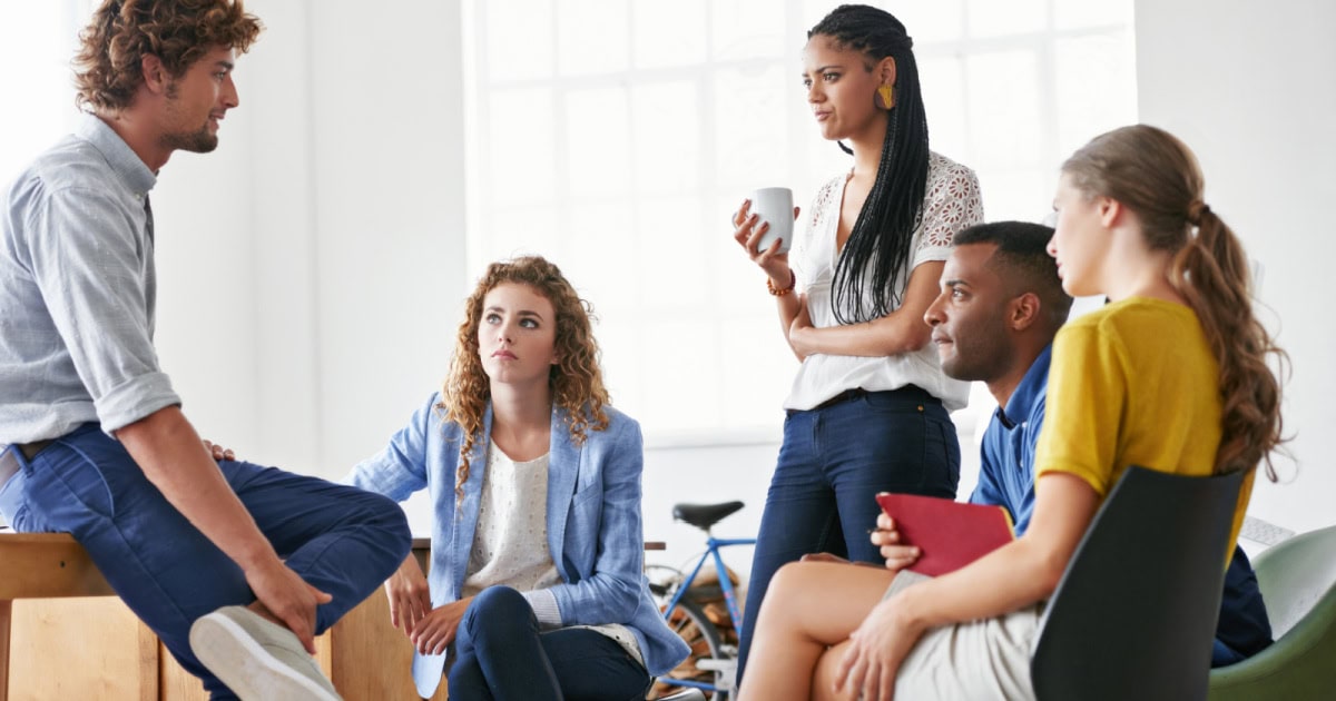 a group of young coworkers have a meeting