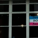 EHRC: A 'Trans Rights Matter' sign displayed in one pane of a large glass window which is dark