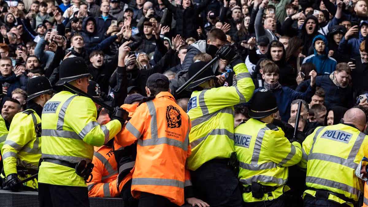 LONDON, ENGLAND - FEBRUARY 04:  West Ham fans are escorted by police towards the stadium before the npower Championship match between West Ham United and Millwall, at Boleyn Ground on February 04, 2012 in London, England. To prevent potential clashes between supporters of the two London rival teams, mounted police escorted fans to West Ham United's Boleyn ground (formerly Upton Park), requesting pubs in the local area to remain closed before the match kicked off at 12:30pm.  (Photo by Matthew Lloyd/Getty Images)