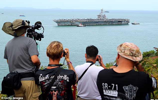 The USS Abraham Lincoln aircraft carrier is pictured arriving at Laem Chabang Port on Wednesday following its extended deployment to the Middle East