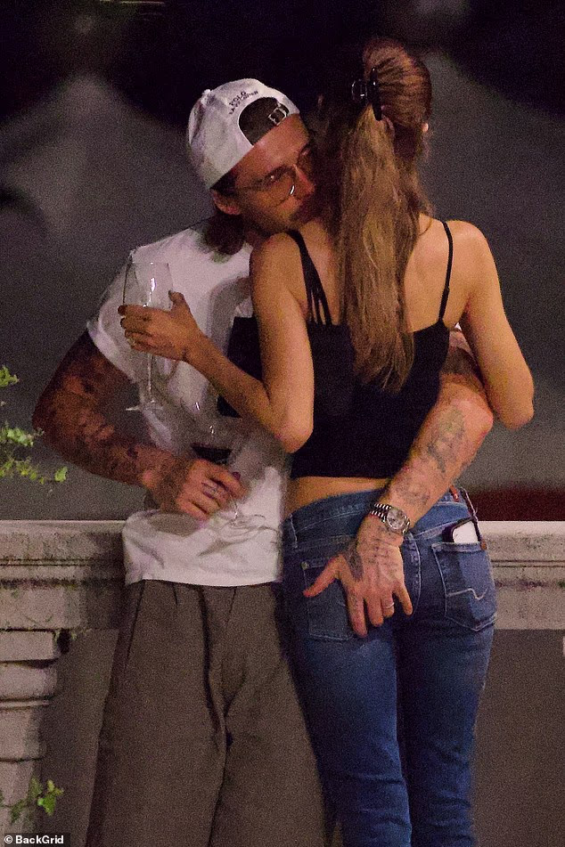 Brooklyn Brooklyn and Nicola Peltz cosied up to one another as they drank red wine in Venice on Thursday night - ahead of her receiving a 'rising star' award