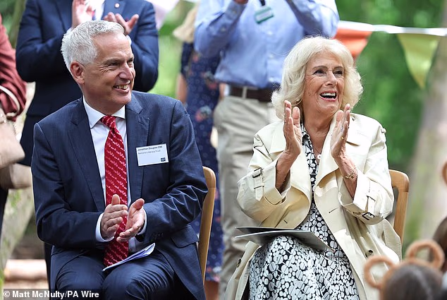 Camilla, 79, couldn't stop smiling as she joined families in Speke Hall for an interactive storytelling session led by Julia and Gruffalo's co-creator Axel Scheffler. She is seen here with Jonathan Douglas, the chief executive of the National Literary Trust