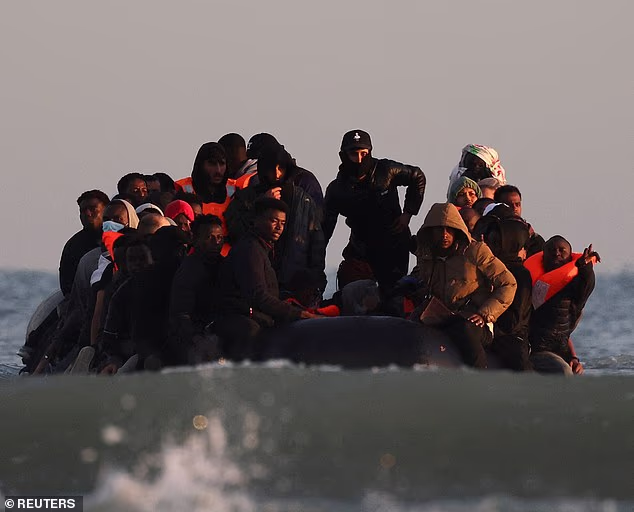 Migrants today scrambled on board a dinghy in an attempt to cross the English Channel to Britain