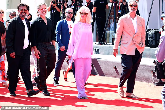 Pamela Anderson, 59, wore a floaty lilac chiffon ensemble as she arrived on the red carpet for the Golden Lion opening ceremony in Venice on Monday