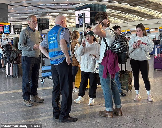 Passengers ask for information as London Heathrow Airport today as disruption continues