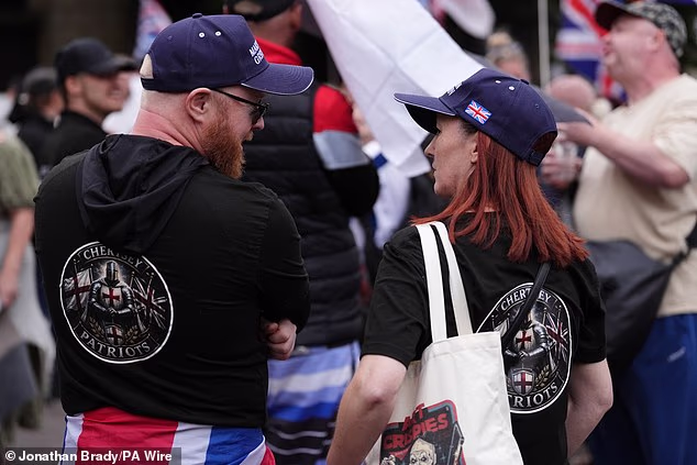 Anti-migrant protesters in Portsmouth on Saturday. The demonstration follows several protests by Right-wing groups since last weekend, after several hundred men dressed in black and wearing balaclavas blocked access to the port of Dover