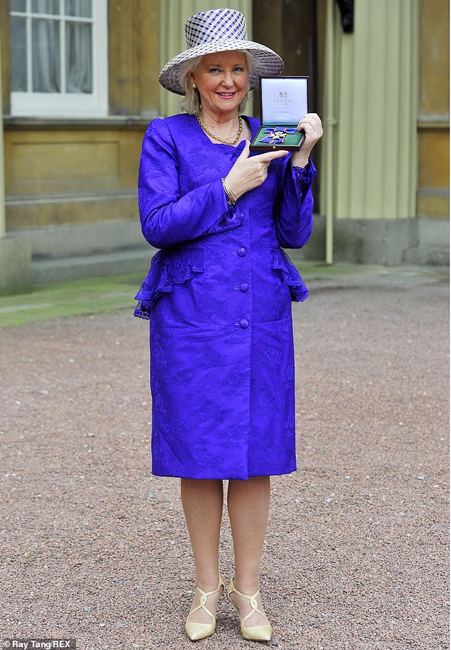 Queen Elizabeth's 'gatekeeper' Angela Kelly has agreed to cooperate with a film about her life story (Pictured: Ms Kelly receiving the Royal Victoria Order Investitures at Buckingham Palace)